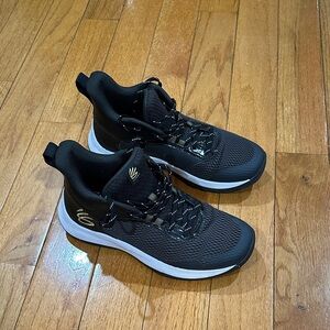 Basketball sneakers. Curry.
Black with gold accents.